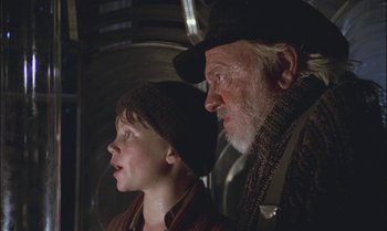 Movie still from “Pete's Dragon” (1977), directed by Don Chaffey – An older man and a young boy looking at each other; Close Up shot, Low angle