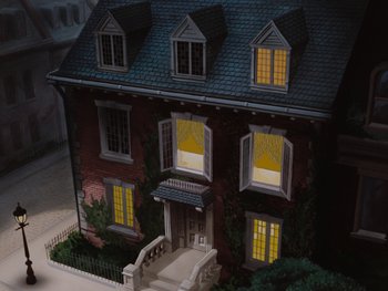 Movie still from “Peter Pan” (1953), directed by Jack Kinney – A model of a house lit up at night time; Extreme Wide shot, High angle