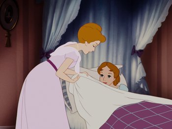 Movie still from “Peter Pan” (1953), directed by Jack Kinney – A woman and a child in a bed; Medium shot, High angle