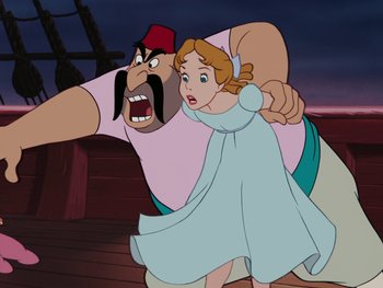 Movie still from “Peter Pan” (1953), directed by Jack Kinney – A woman and a man are in a cartoon; Medium shot, Over the shoulder angle
