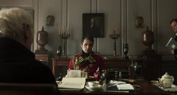 Movie still from “Peterloo” (2018), directed by Mike Leigh – A man sitting at a desk in a room; Medium shot, Over the shoulder angle