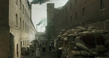 Movie still from “Peterloo” (2018), directed by Mike Leigh – A group of people walking down a street near a building; Extreme Wide shot, High angle