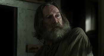 Movie still from “Peterloo” (2018), directed by Mike Leigh – A man with a long beard is looking at the camera; Close Up shot, Over the shoulder angle