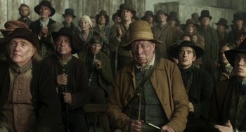Movie still from “Peterloo” (2018), directed by Mike Leigh – A group of people standing in front of a wall; Medium shot, High angle