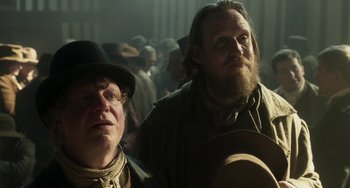 Movie still from “Peterloo” (2018), directed by Mike Leigh – Two men are standing in a crowd of people; Close Up shot, Low angle
