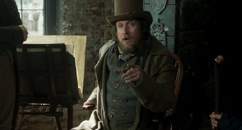 Movie still from “Peterloo” (2018), directed by Mike Leigh – A man wearing a top hat and a coat; Medium shot, Over the shoulder angle
