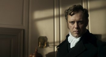 Movie still from “Peterloo” (2018), directed by Mike Leigh – A man wearing a black coat and a white shirt; Close Up shot, Over the shoulder angle