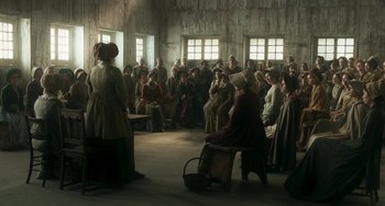 Movie still from “Peterloo” (2018), directed by Mike Leigh – A group of people sitting in a room; Wide shot, High angle