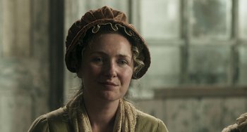 Movie still from “Peterloo” (2018), directed by Mike Leigh – A woman wearing a brown hat and a scarf; Close Up shot, Over the shoulder angle