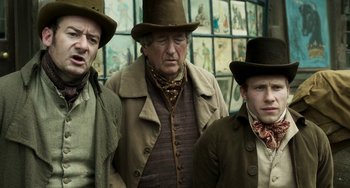 Movie still from “Peterloo” (2018), directed by Mike Leigh – A group of men standing next to each other wearing hats; Medium shot, Low angle