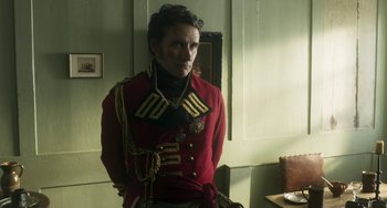 Movie still from “Peterloo” (2018), directed by Mike Leigh – A man dressed in a red jacket and black and gold uniform; Medium shot, Over the shoulder angle
