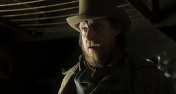 Movie still from “Peterloo” (2018), directed by Mike Leigh – A man with a beard wearing a hat and jacket; Close Up shot, Low angle