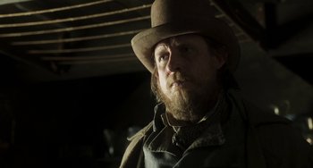 Movie still from “Peterloo” (2018), directed by Mike Leigh – A man with a beard wearing a hat and jacket; Close Up shot, Low angle