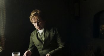 Movie still from “Peterloo” (2018), directed by Mike Leigh – A man in a green jacket looking at his watch; Medium shot, High angle