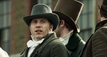 Movie still from “Peterloo” (2018), directed by Mike Leigh – A man in a top hat and a man in a suit; Close Up shot, Over the shoulder angle