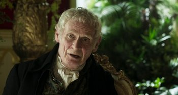 Movie still from “Peterloo” (2018), directed by Mike Leigh – An older man with white hair and a black jacket; Close Up shot, Over the shoulder angle