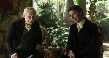 Movie still from “Peterloo” (2018), directed by Mike Leigh – Two men sitting next to each other in front of a table; Medium shot, Over the shoulder angle