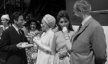 Movie still from “Phaedra” (1962), directed by Jules Dassin – A black and white photo of a group of people; Medium shot, Over the shoulder angle