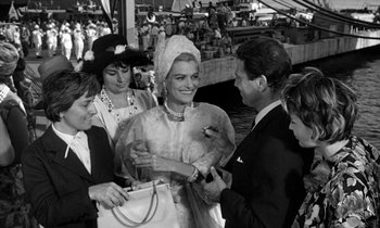 Movie still from “Phaedra” (1962), directed by Jules Dassin – A group of people standing next to each other; Medium shot, High angle