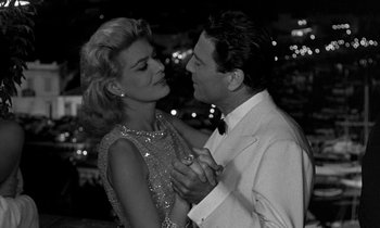 Movie still from “Phaedra” (1962), directed by Jules Dassin – A man and a woman are dancing together; Medium shot, Low angle