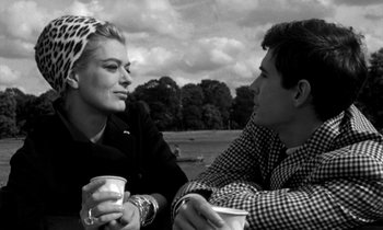 Movie still from “Phaedra” (1962), directed by Jules Dassin – A man and a woman sitting next to each other holding drinks; Close Up shot, Over the shoulder angle