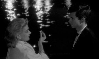 Movie still from “Phaedra” (1962), directed by Jules Dassin – A man and a woman holding a cell phone; Close Up shot, High angle