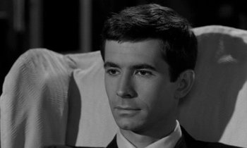 Movie still from “Phaedra” (1962), directed by Jules Dassin – Black and white photograph of a man in a suit and tie; Close Up shot, High angle