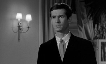 Movie still from “Phaedra” (1962), directed by Jules Dassin – Black and white photograph of a man wearing a suit and tie; Close Up shot, Low angle