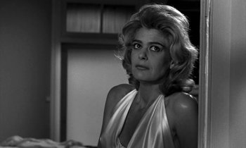 Movie still from “Phaedra” (1962), directed by Jules Dassin – A black - and - white photo of a woman in a white dress; Close Up shot, Low angle