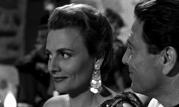 Movie still from “Phaedra” (1962), directed by Jules Dassin – An old photo of a man and a woman looking at each other; Close Up shot, Over the shoulder angle