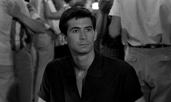 Movie still from “Phaedra” (1962), directed by Jules Dassin – Black and white photograph of a man in a crowd; Close Up shot, Over the shoulder angle