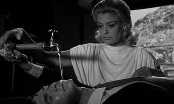 Movie still from “Phaedra” (1962), directed by Jules Dassin – An old photo of a woman washing a man's face; Medium shot, High angle