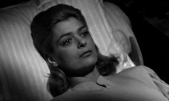 Movie still from “Phaedra” (1962), directed by Jules Dassin – An old photo of a woman laying on a bed; Close Up shot, High angle