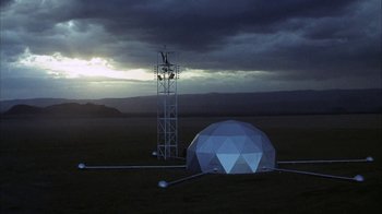 Movie still from “Phase IV” (1974), directed by Saul Bass – A large white dome sitting on top of a grass covered field; Extreme Wide shot, Low angle