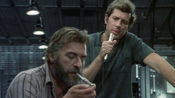 Movie still from “Phase IV” (1974), directed by Saul Bass – Two men are smoking and one is holding a microphone; Close Up shot, Low angle