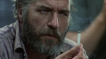 Movie still from “Phase IV” (1974), directed by Saul Bass – A person holding a cigarette; Close Up shot, Low angle