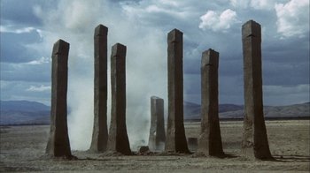 Movie still from “Phase IV” (1974), directed by Saul Bass – A group of tall stone pillars in the middle of the desert; Extreme Wide shot, Low angle