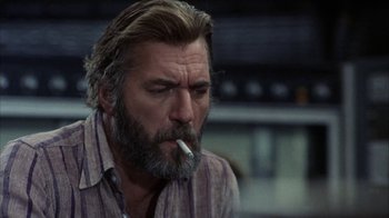 Movie still from “Phase IV” (1974), directed by Saul Bass – A person smoking a cigarette; Close Up shot, Low angle