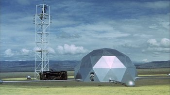 Movie still from “Phase IV” (1974), directed by Saul Bass – An old car parked in front of a large geodesic dome; Extreme Wide shot, Low angle
