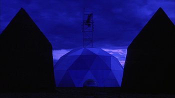 Movie still from “Phase IV” (1974), directed by Saul Bass – A large dome with a tower on top of it in the dark; Extreme Wide shot, Low angle