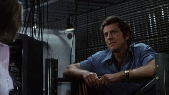 Movie still from “Phase IV” (1974), directed by Saul Bass – A man sitting in front of a television set; Medium shot, Low angle