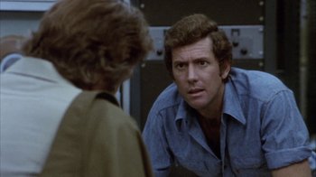 Movie still from “Phase IV” (1974), directed by Saul Bass – A man looking at a woman in the mirror; Close Up shot, Over the shoulder angle