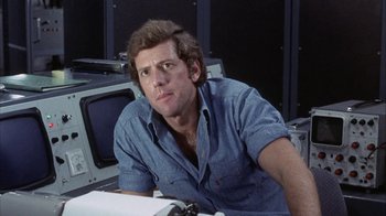 Movie still from “Phase IV” (1974), directed by Saul Bass – A man sitting in front of a television set; Close Up shot, Low angle