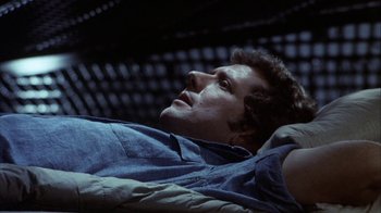 Movie still from “Phase IV” (1974), directed by Saul Bass – A man laying on the ground looking up at the sky; Close Up shot, Overhead angle