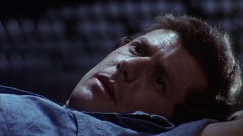 Movie still from “Phase IV” (1974), directed by Saul Bass – A person laying in a bed; Close Up shot, High angle