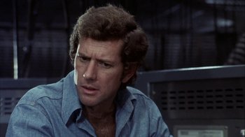 Movie still from “Phase IV” (1974), directed by Saul Bass – A person wearing a blue shirt; Close Up shot, Over the shoulder angle