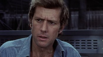 Movie still from “Phase IV” (1974), directed by Saul Bass – A person wearing a blue shirt; Close Up shot, Over the shoulder angle