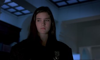 Movie still from “Phenomena” (1985), directed by Dario Argento – A woman with long dark hair wearing a black jacket; Close Up shot, Over the shoulder angle