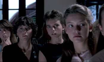 Movie still from “Phenomena” (1985), directed by Dario Argento – A group of young women standing next to each other; Close Up shot, Low angle
