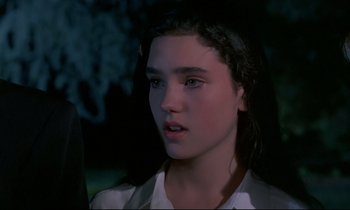 Movie still from “Phenomena” (1985), directed by Dario Argento – A young girl is looking into the distance; Close Up shot, Over the shoulder angle